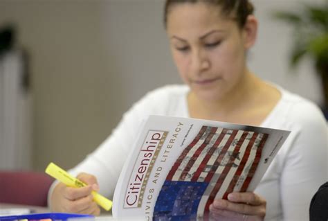 Immigrant studying a U.S. civics booklet to prepare for the citizenship test